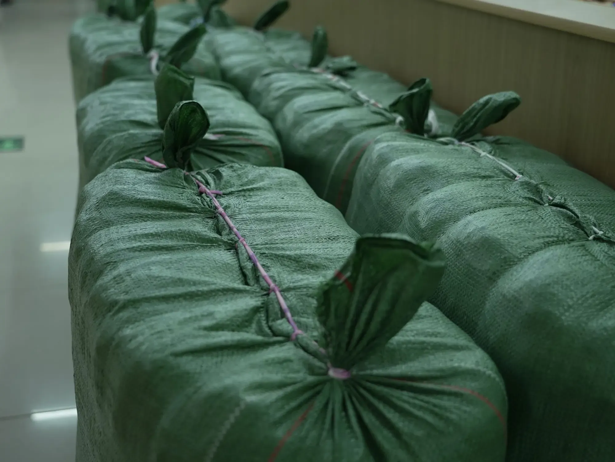 Packed bales of garments stitched closed for shipping