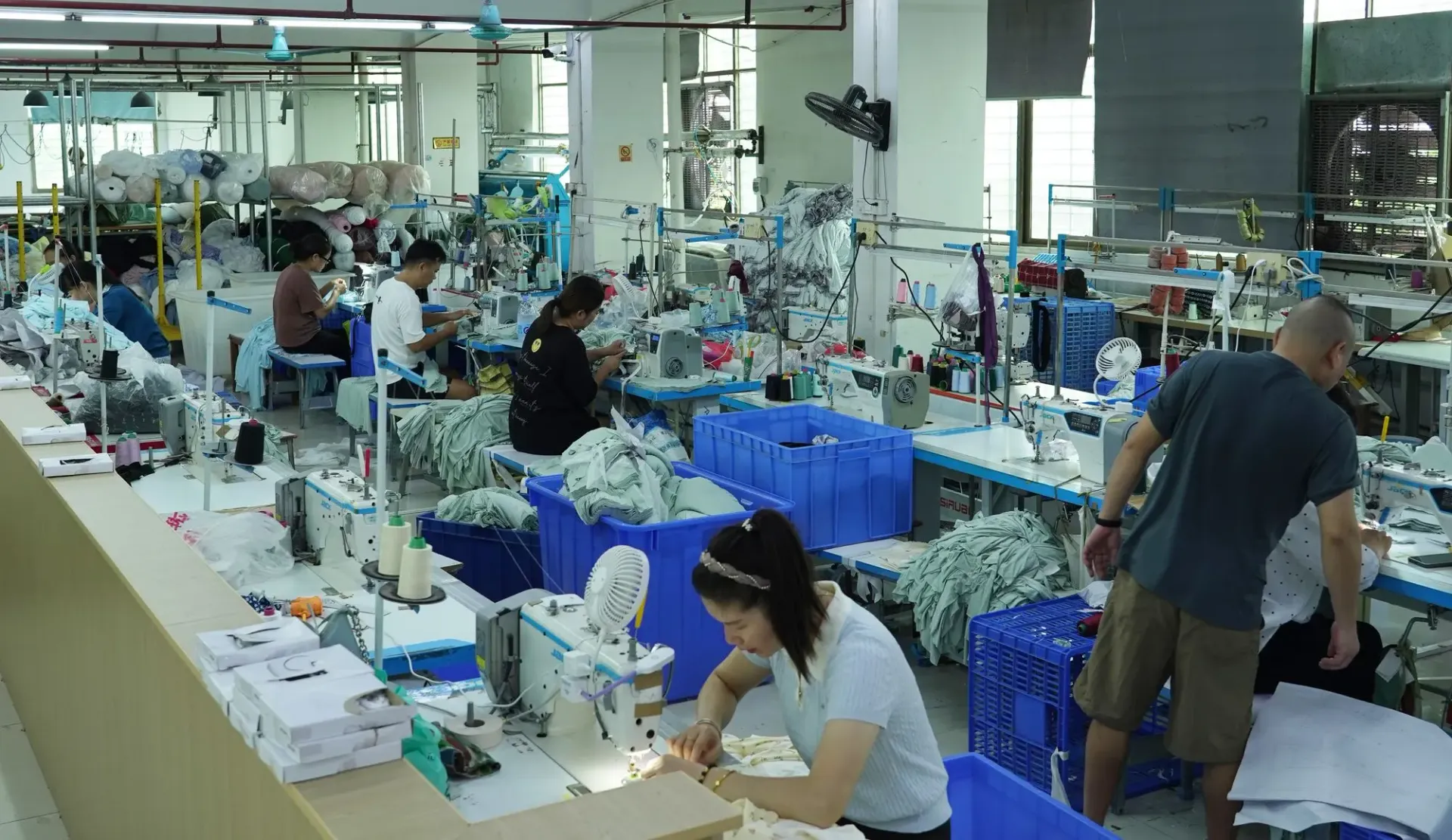 Sewing lines on the factory floor in Dongguan, with operators at their machines