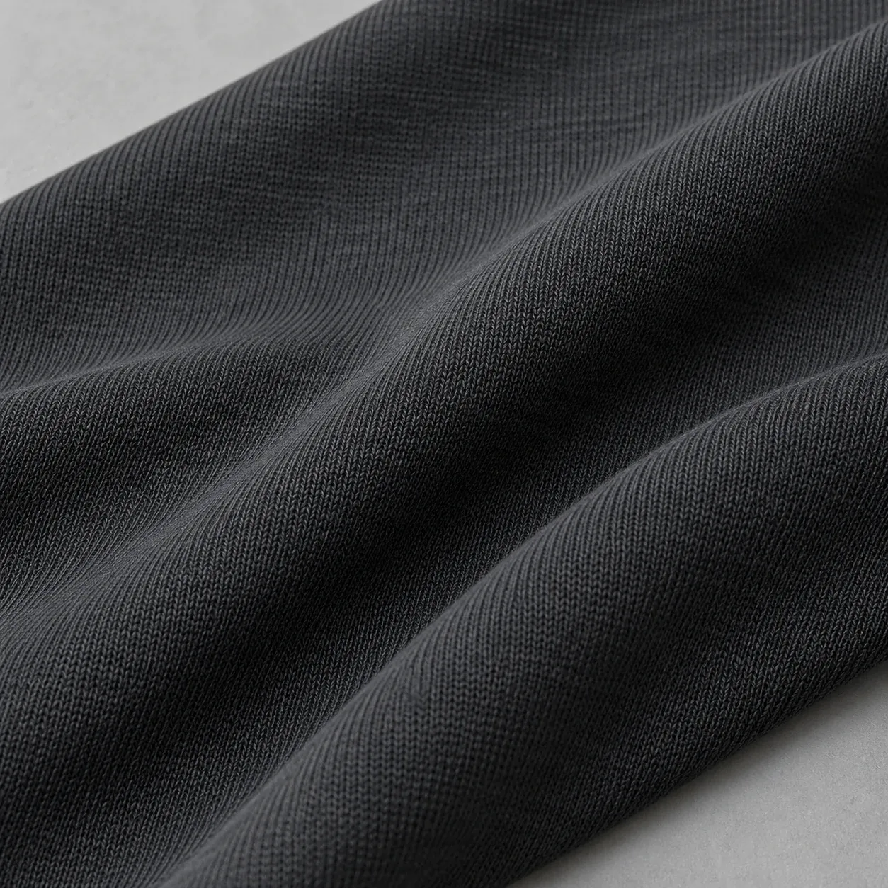 Close view of charcoal stretch fabric in soft folds